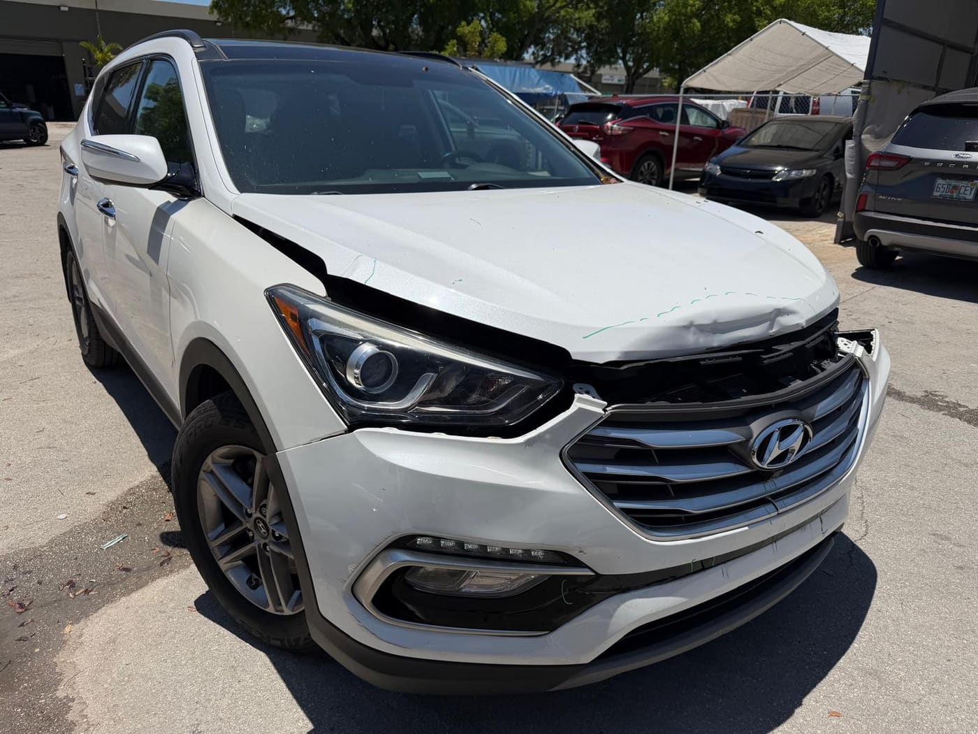 The same Hyundai Santa Fe before repair, showing collision damage